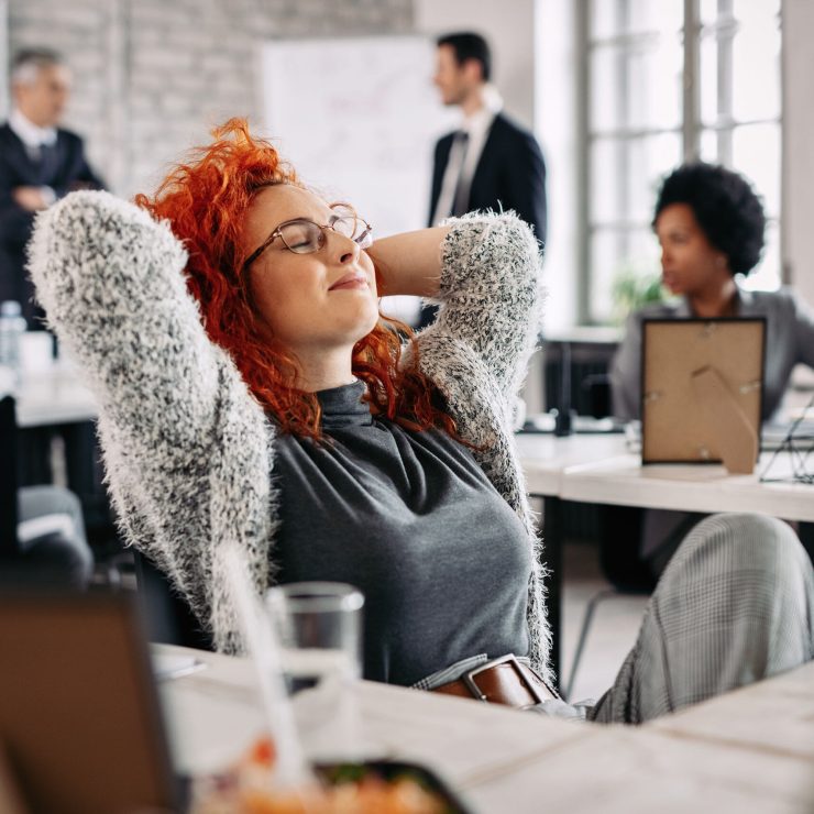 young-creative-businesswoman-with-hands-head-taking-break-resting-with-eyes-closed-office2