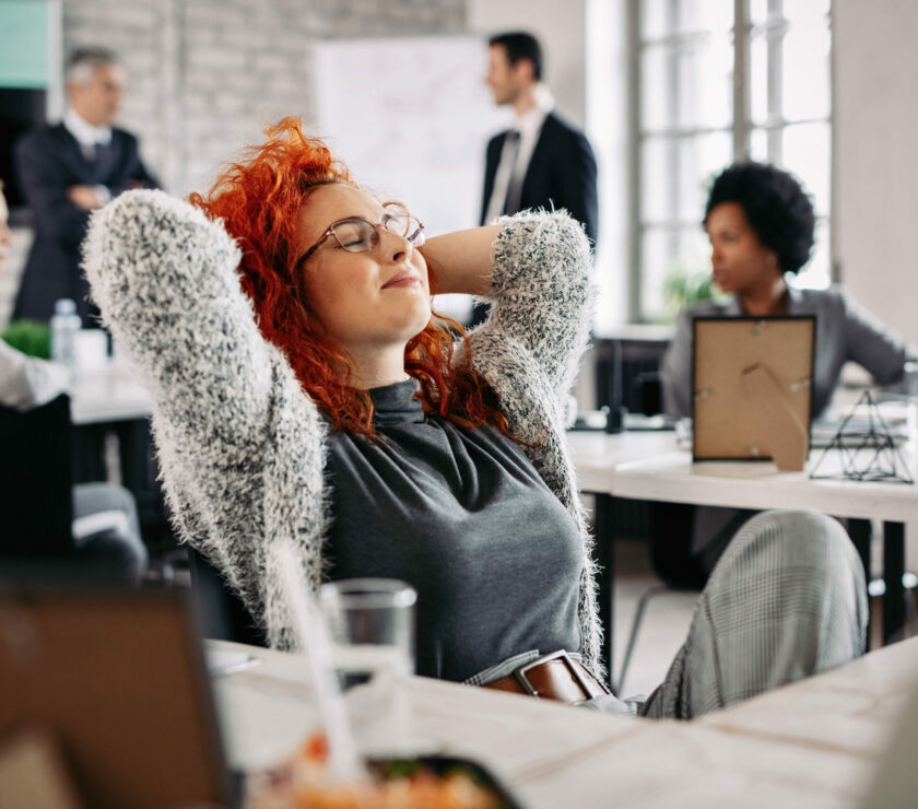young-creative-businesswoman-with-hands-head-taking-break-resting-with-eyes-closed-office2